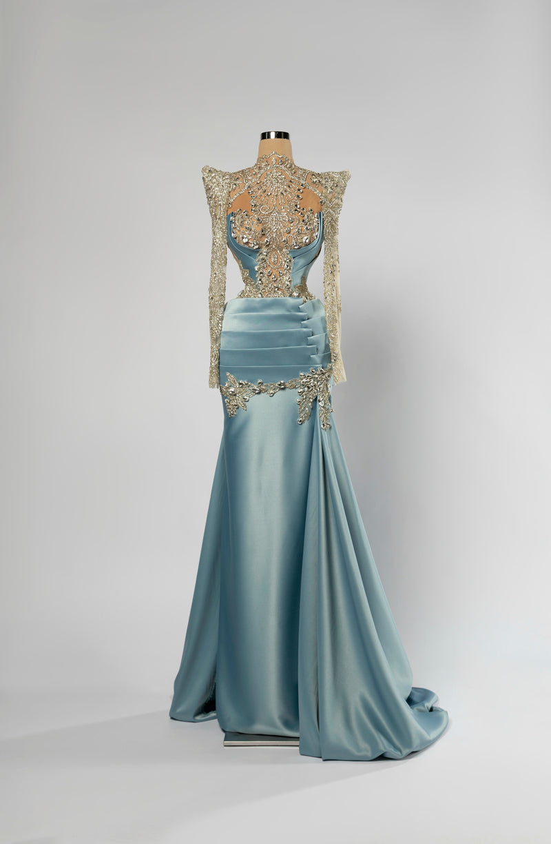 Sihëna Aquamarine Regent — powder-blue high-neck long-sleeve mermaid evening gown in satin with crystal illusion bodice and overskirt train.