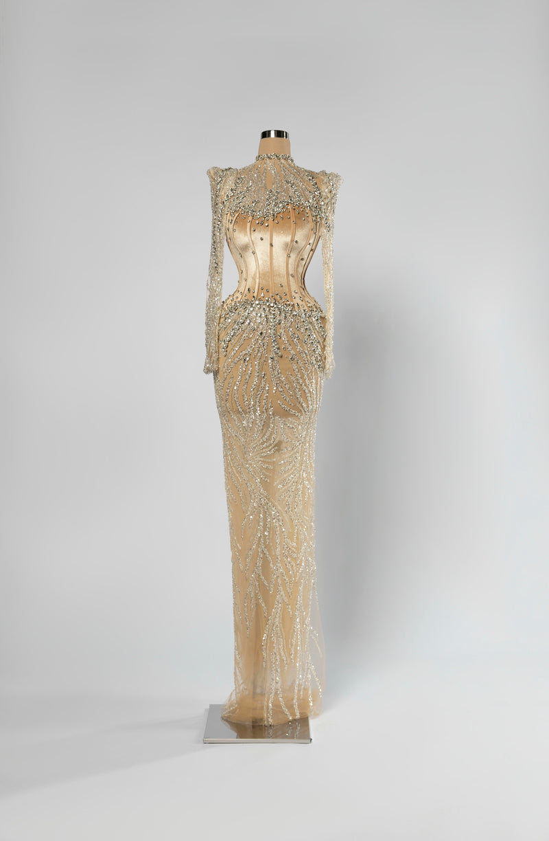 Sihëna Auric Lattice — champagne high-neck long-sleeve column evening gown with crystal illusion shoulders and beaded sheer skirt over a corset.