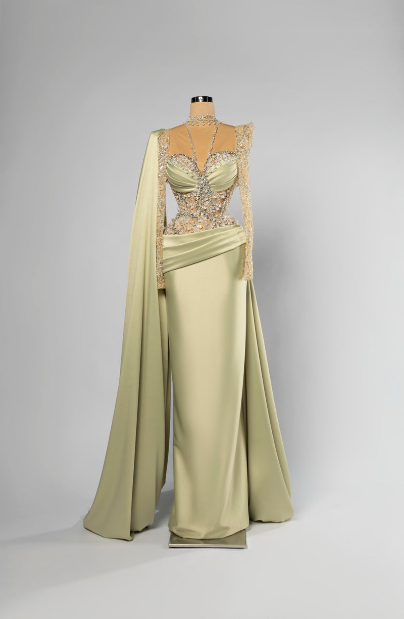 Sihëna Elysian Sage — sage-green high-neck long-sleeve column evening gown in satin with crystal-pearl illusion bodice and shoulder cape.
