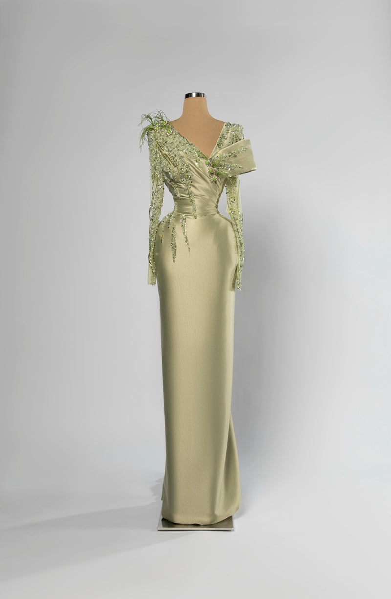 Sihëna Sage Meridian — sage-green asymmetric off-shoulder column evening gown in satin with beaded floral shoulder and feather accent.