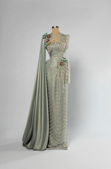 Sihëna Willow Opus — sage-green sweetheart long-sleeve mermaid gown with dense crystal and pearl beadwork, 3D floral and draped satin cape train.