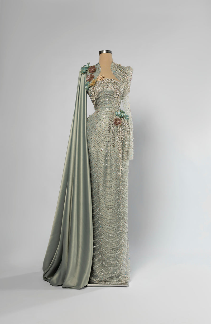 Sihëna Willow Opus — sage-green sweetheart long-sleeve mermaid gown with dense crystal and pearl beadwork, 3D floral and draped satin cape train.