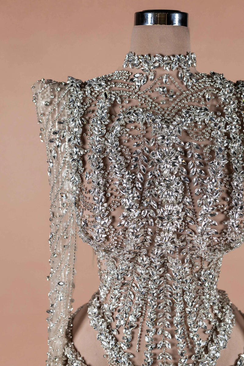 Sihëna Prismatic Cascade — silver high-neck long-sleeve column evening dress