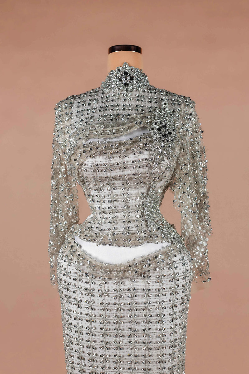Sihëna Ivory Armor — silver high-neck long-sleeve column evening dress