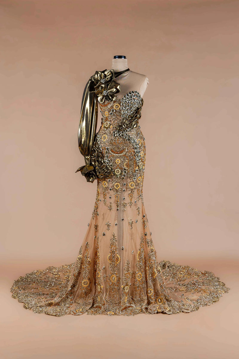 Sihëna Gilded Flora — gold sweetheart one-shoulder mermaid gown with gold floral lace-appliqué, crystal beadwork and metallic draped sleeve.