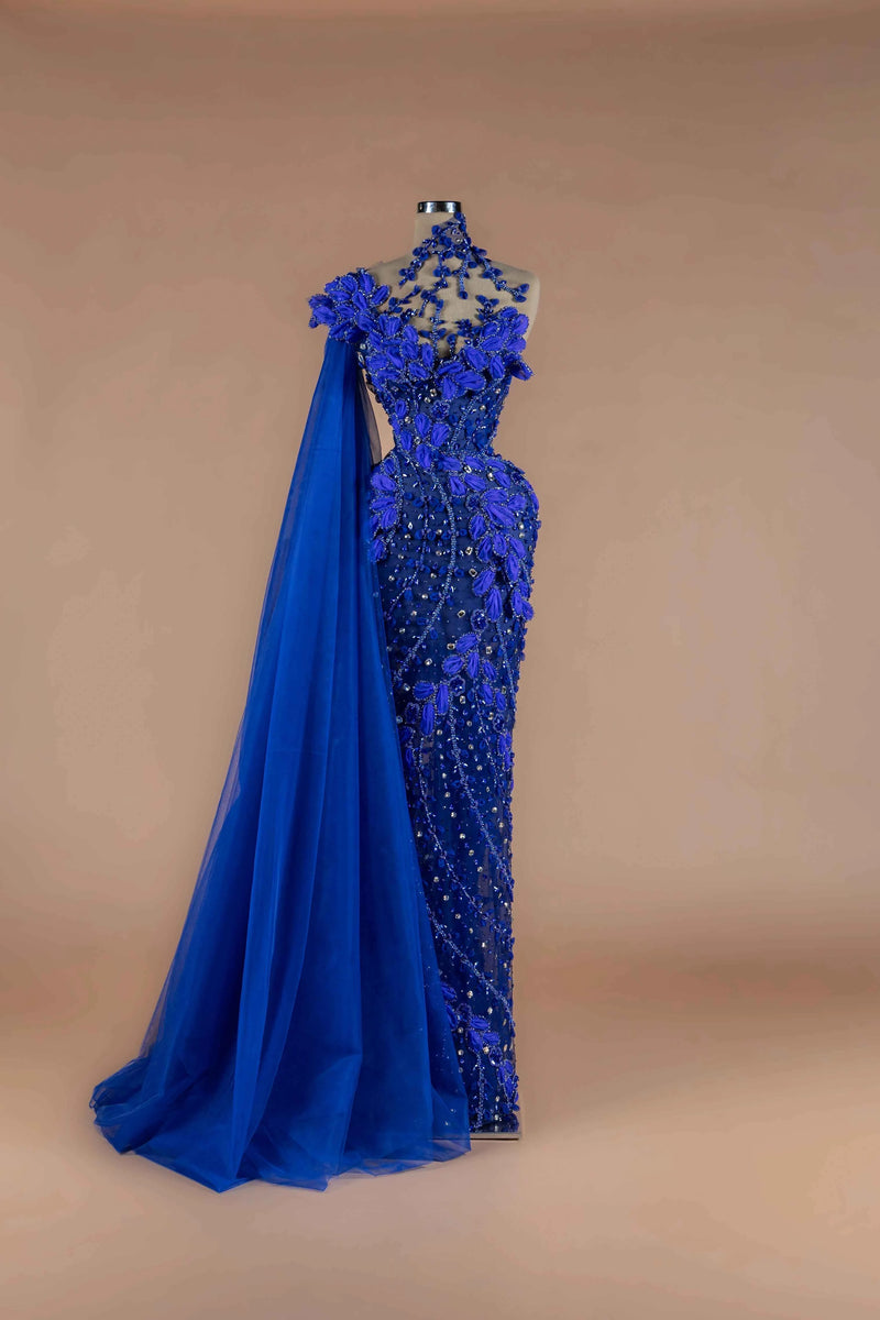 Sihëna Cobalt Petal — cobalt one-shoulder column gown with 3D-floral petals, crystal beadwork and a flowing tulle cape.