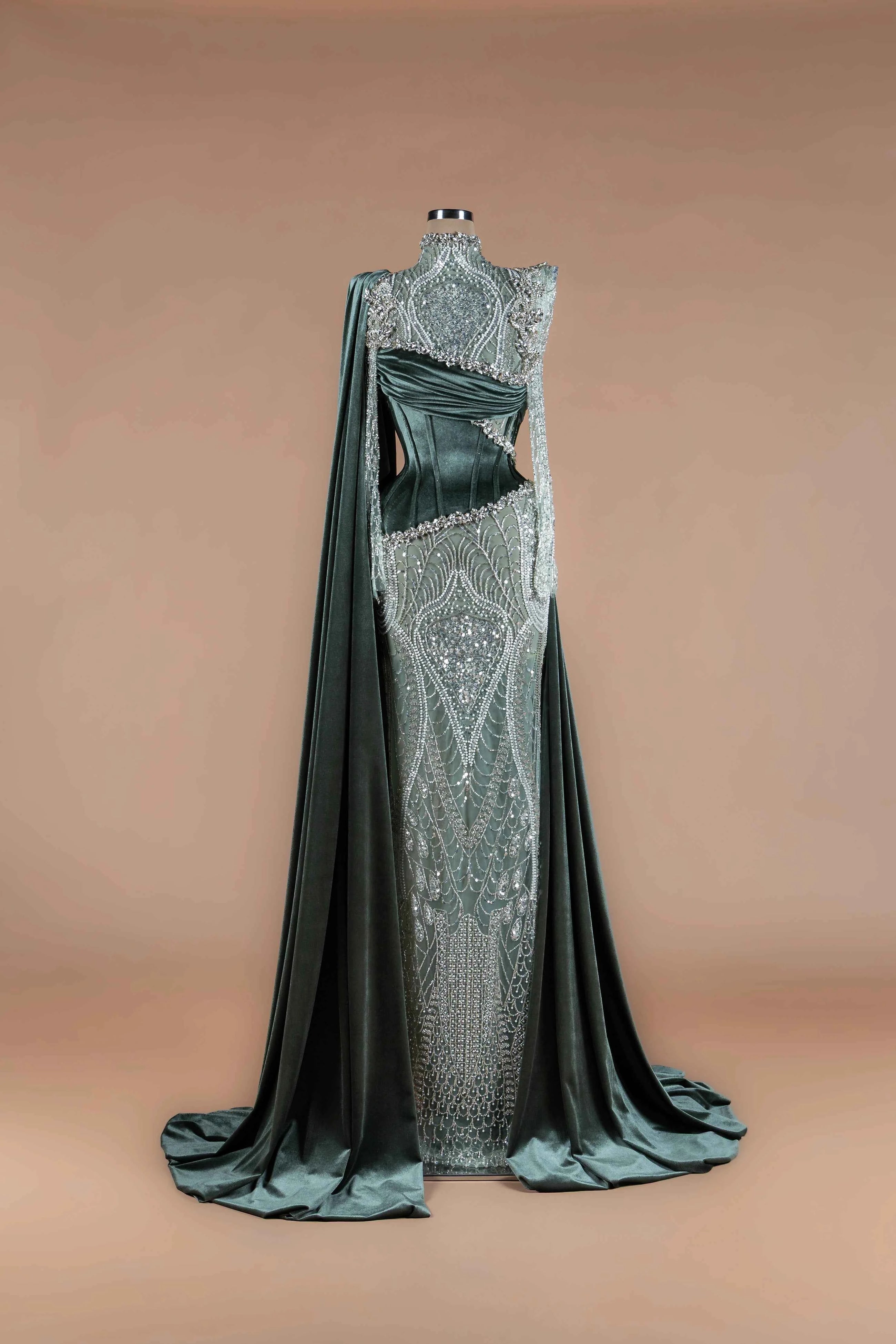 Sihëna Evergreen Citadel — emerald high-neck long-sleeve velvet gown with crystal-sequin panel, caped sleeves and corset midriff.