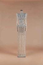 Sihëna Prismatic Cascade — silver high-neck long-sleeve column gown encrusted with crystal and beadwork on sheer nude tulle.
