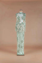 Sihëna Sage Ivy — sage-green high-neck long-sleeve column gown with green floral beadwork on sheer tulle and caped shoulders.