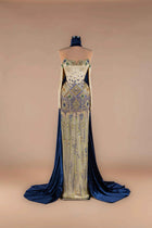 Sihëna Indigo Mosaic — navy strapless off-shoulder mermaid gown with gold-and-blue mosaic beadwork and navy velvet cape train.