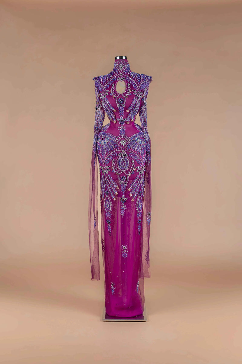 Sihëna Magenta Mirage — magenta high-neck long-sleeve column gown with blue-and-purple crystal beadwork and chest keyhole cutout.