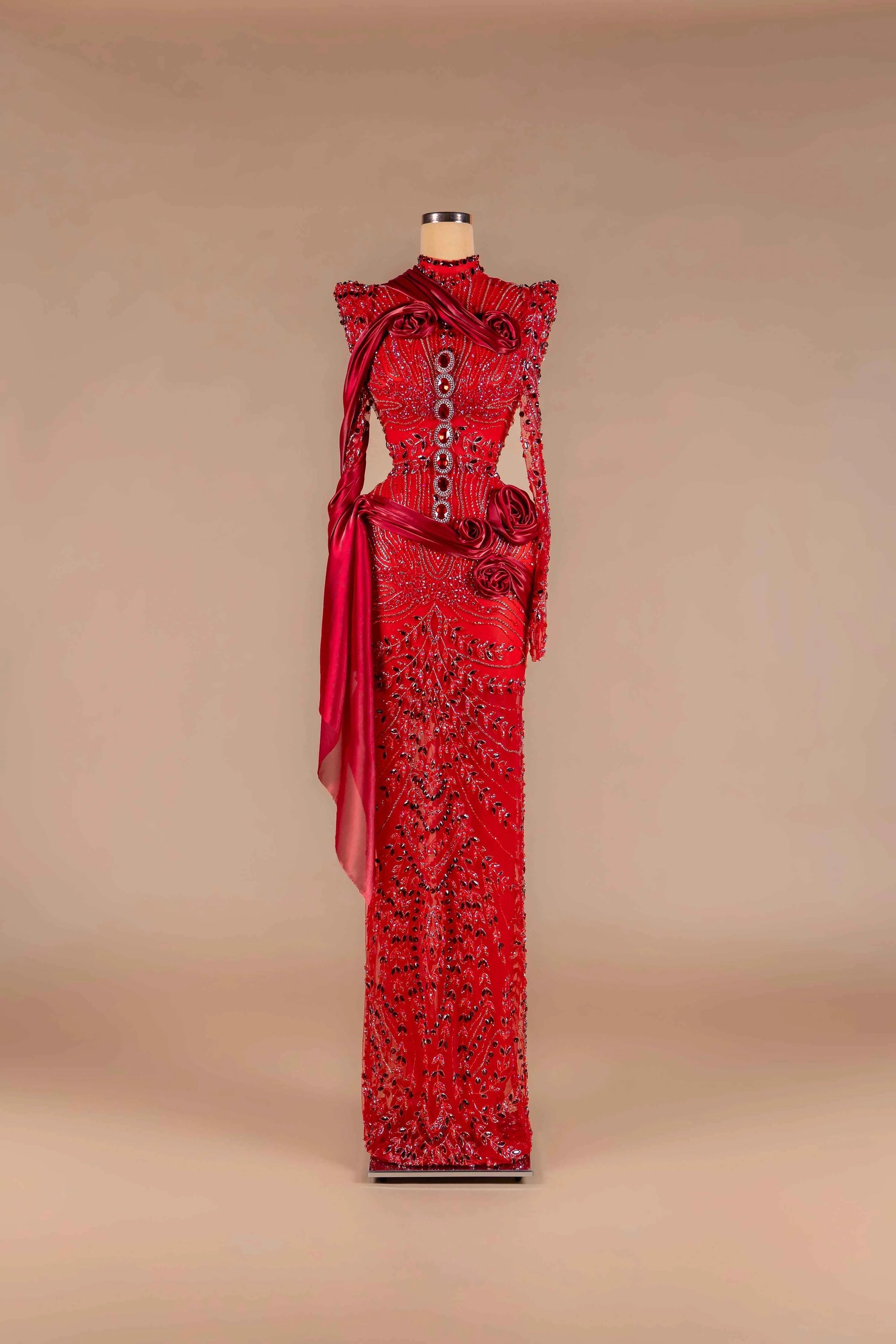 Sihëna Scarlet Rosalia — red high-neck long-sleeve column gown with crystal beadwork, satin sash and 3D rose appliqué.