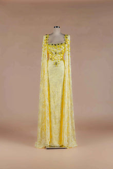 Sihëna Citrine Heirloom — marigold square-neckline lace column gown with crystal-and-bead floral stones and lace cape panels.