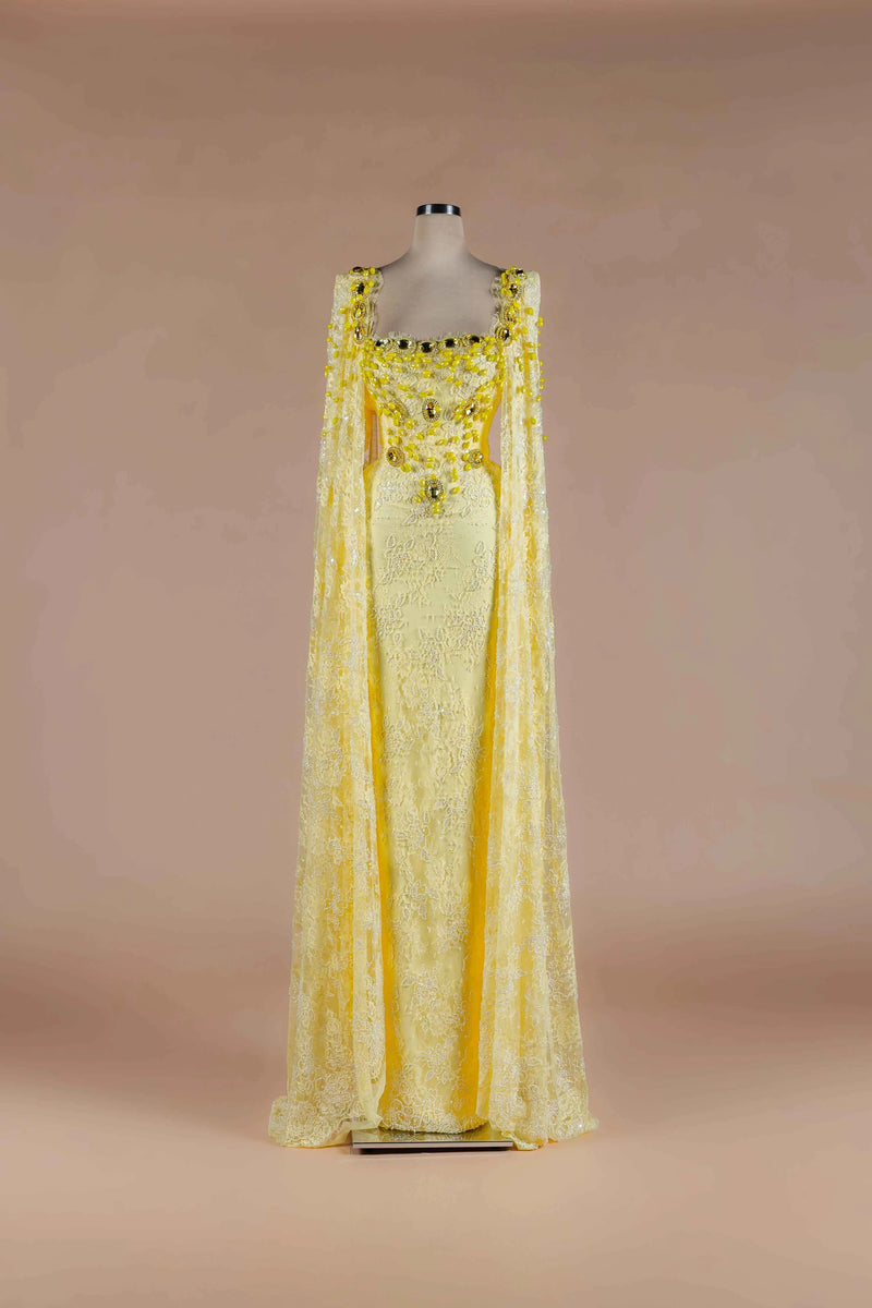 Sihëna Citrine Heirloom — marigold square-neckline lace column gown with crystal-and-bead floral stones and lace cape panels.