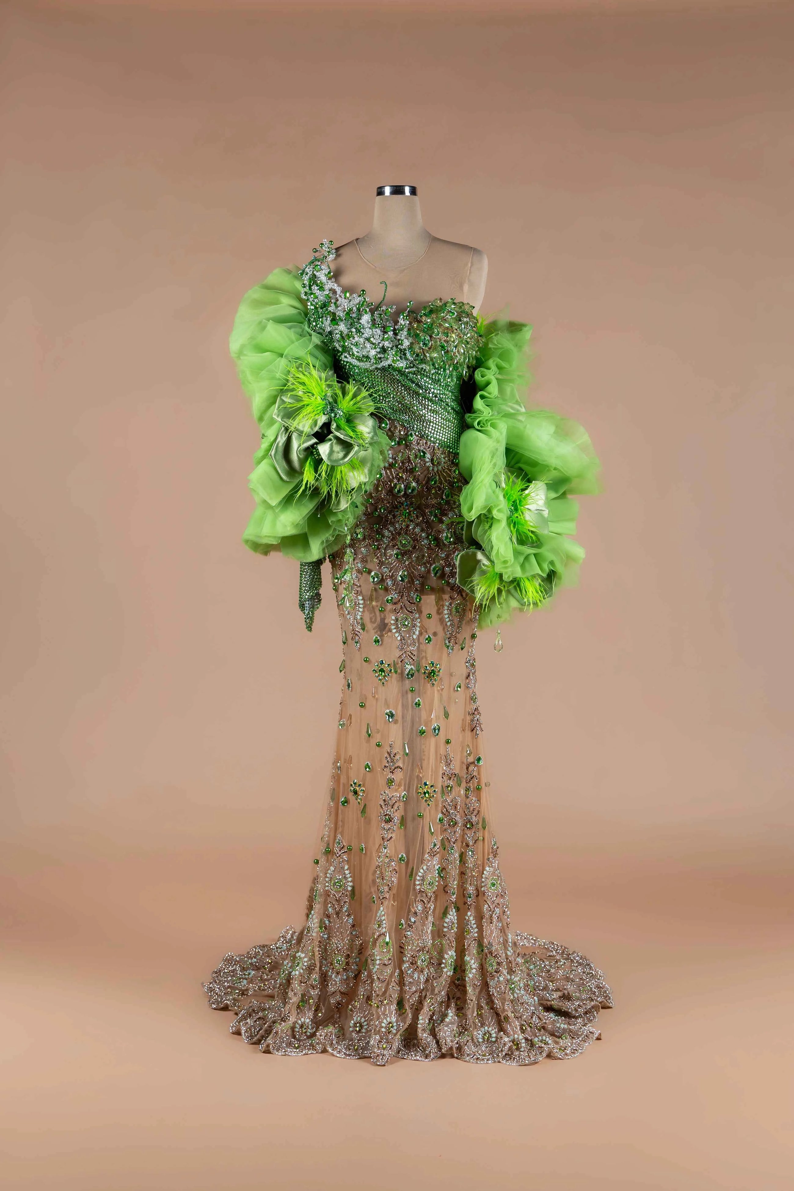 Sihëna Jade Opulence — lime one-shoulder mermaid gown with green crystal beadwork, organza ruffle wraps and satin bows.