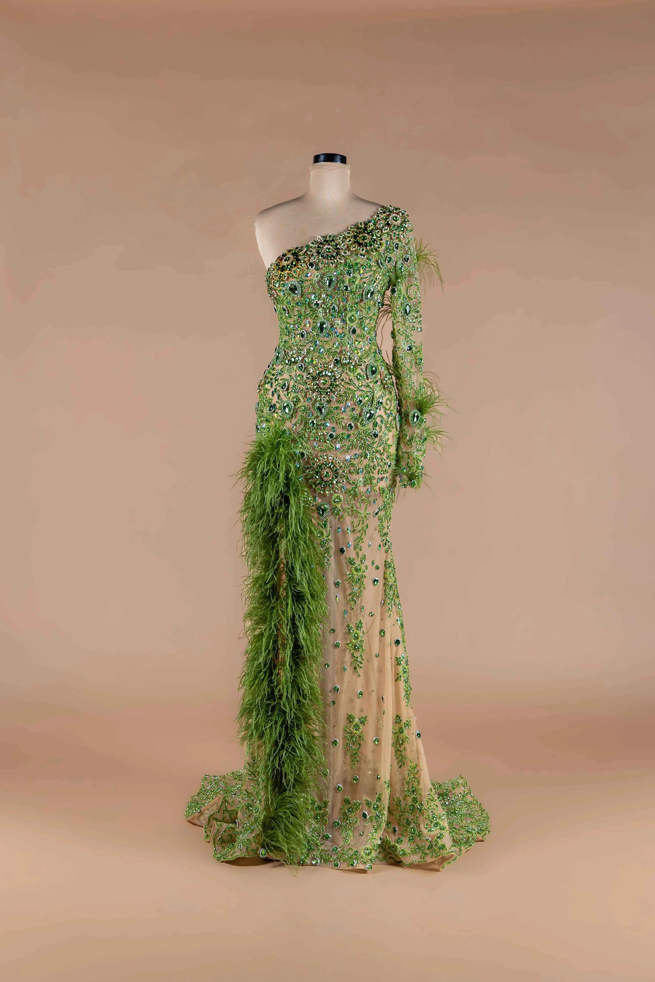 Sihëna Peridot Plume — lime one-shoulder single-sleeve mermaid gown with green crystal beadwork and feather boa trim.