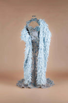 Sihëna Glacial Splendor — powder-blue sweetheart mermaid gown with blue crystal corset, high-neck keyhole collar and feather cape.