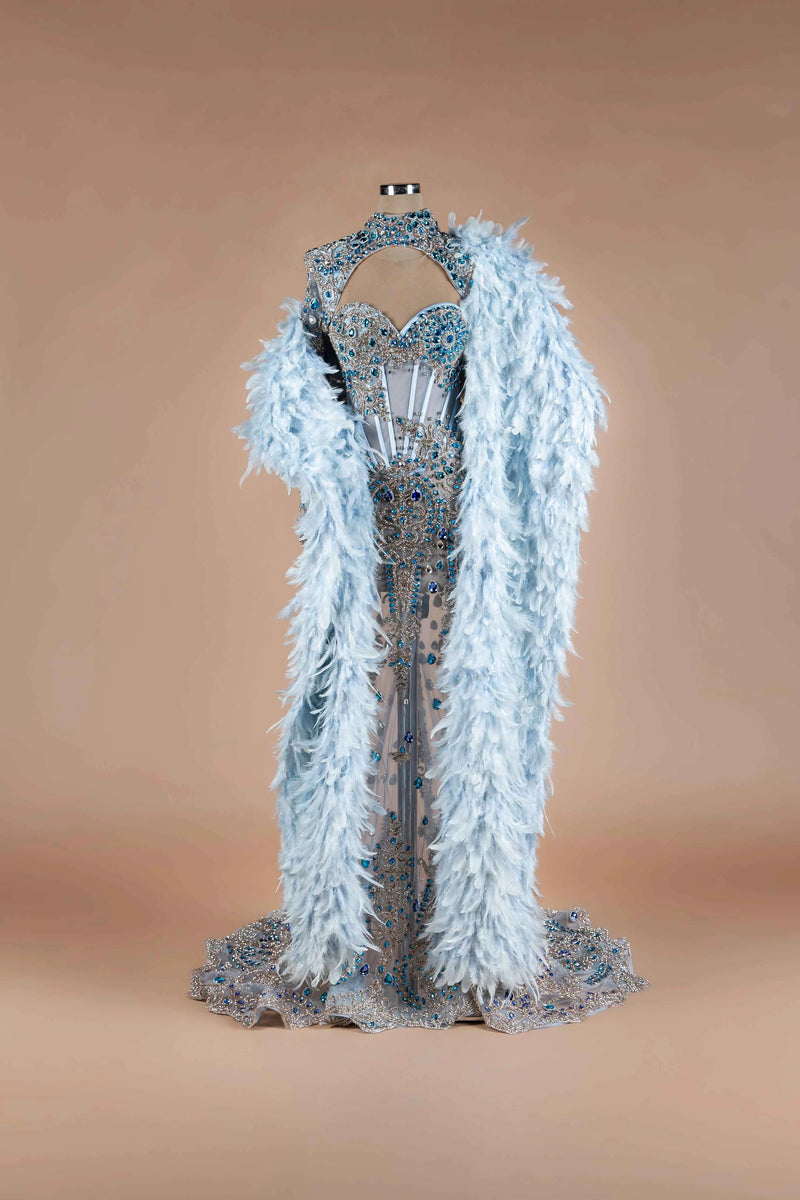 Sihëna Glacial Splendor — powder-blue sweetheart mermaid gown with blue crystal corset, high-neck keyhole collar and feather cape.