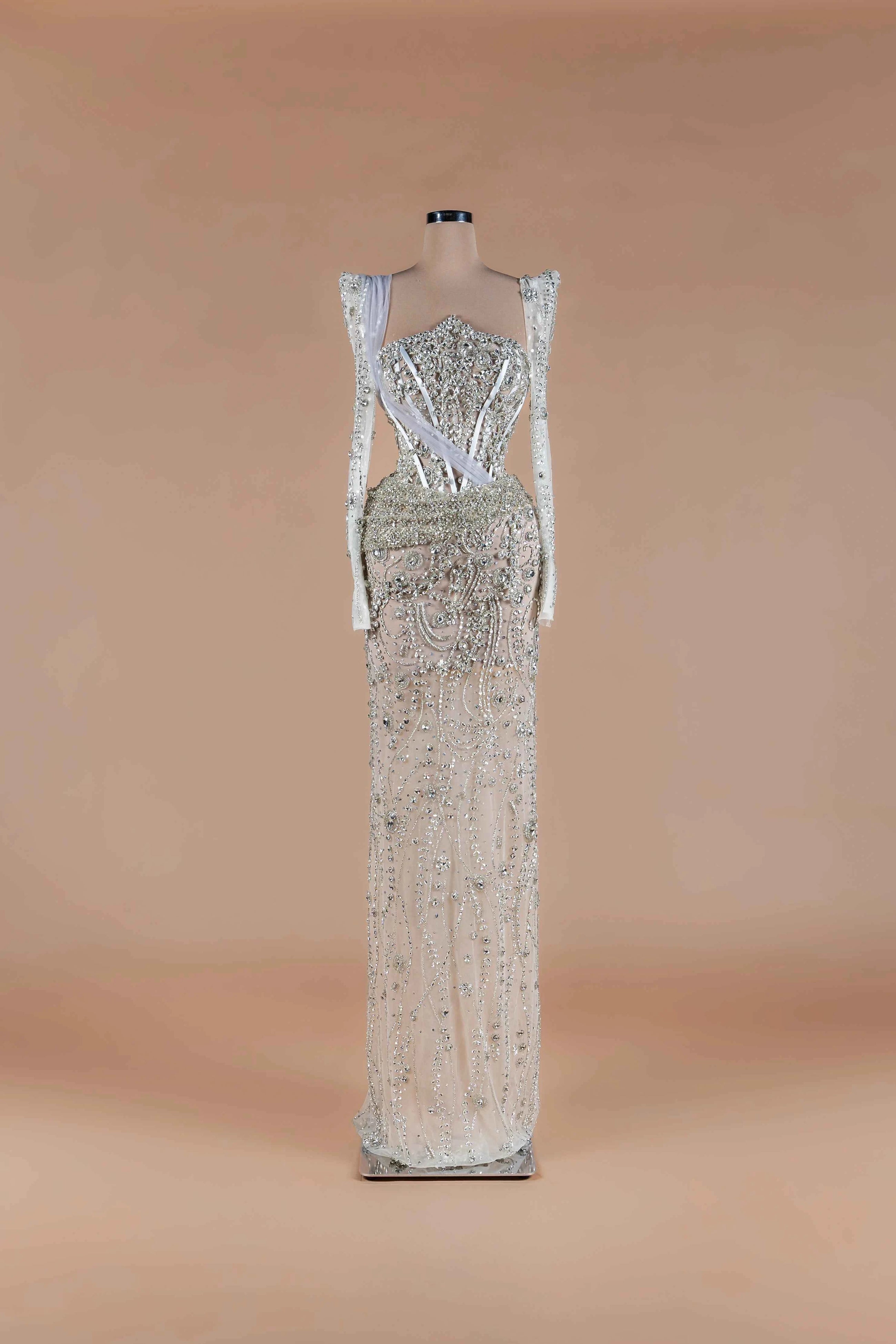Sihëna Diamond Reverie — silver sweetheart long-sleeve column gown with crystal corset bodice and all-over beadwork.