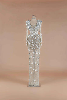 Sihëna Crystalline Garden — silver high-neck long-sleeve column gown with all-over crystal beadwork and 3D white floral appliqué.