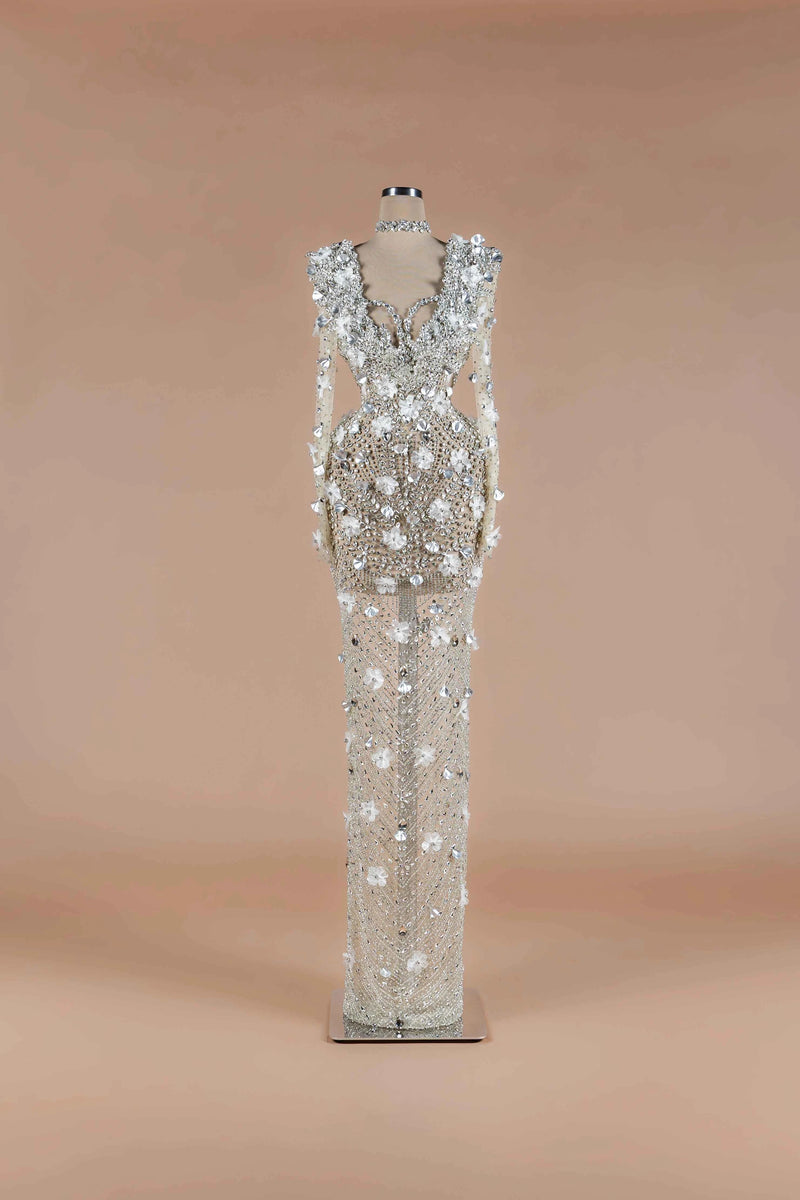 Sihëna Crystalline Garden — silver high-neck long-sleeve column gown with all-over crystal beadwork and 3D white floral appliqué.