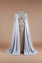 Sihëna Silver Reign — silver high-neck column gown with crystal-beaded sheer bodice and flowing satin cape train.