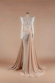 Sihëna Champêtre Glow — champagne high-neck long-sleeve mermaid gown with silver sequin feather-motif beadwork and draped sash with high slit.