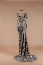 Sihëna Savanna Prowl — leopard-print sequin asymmetric long-sleeve mermaid gown with structured shoulder, draped waist and train.