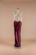 Sihëna Bordeaux Prism — burgundy high-neck long-sleeve column gown with crystal-beaded sheer bodice and draped satin wrap skirt.