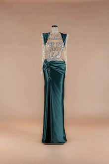 Sihëna Emerald Jewel Crest — emerald high-neck long-sleeve mermaid gown with crystal-beaded sheer bodice and twist-draped satin skirt.