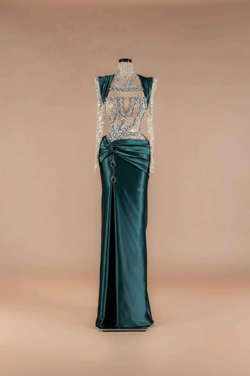 Sihëna Emerald Jewel Crest — emerald high-neck long-sleeve mermaid gown with crystal-beaded sheer bodice and twist-draped satin skirt.