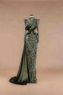Sihëna Olive Brocade — olive high-neck long-sleeve velvet gown with silver-beaded floral appliqué, draped sash and high slit.