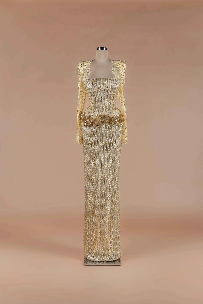 Sihëna Gilded Corset Column — gold square-neck long-sleeve crystal corset gown with beaded lace sleeves and column skirt.