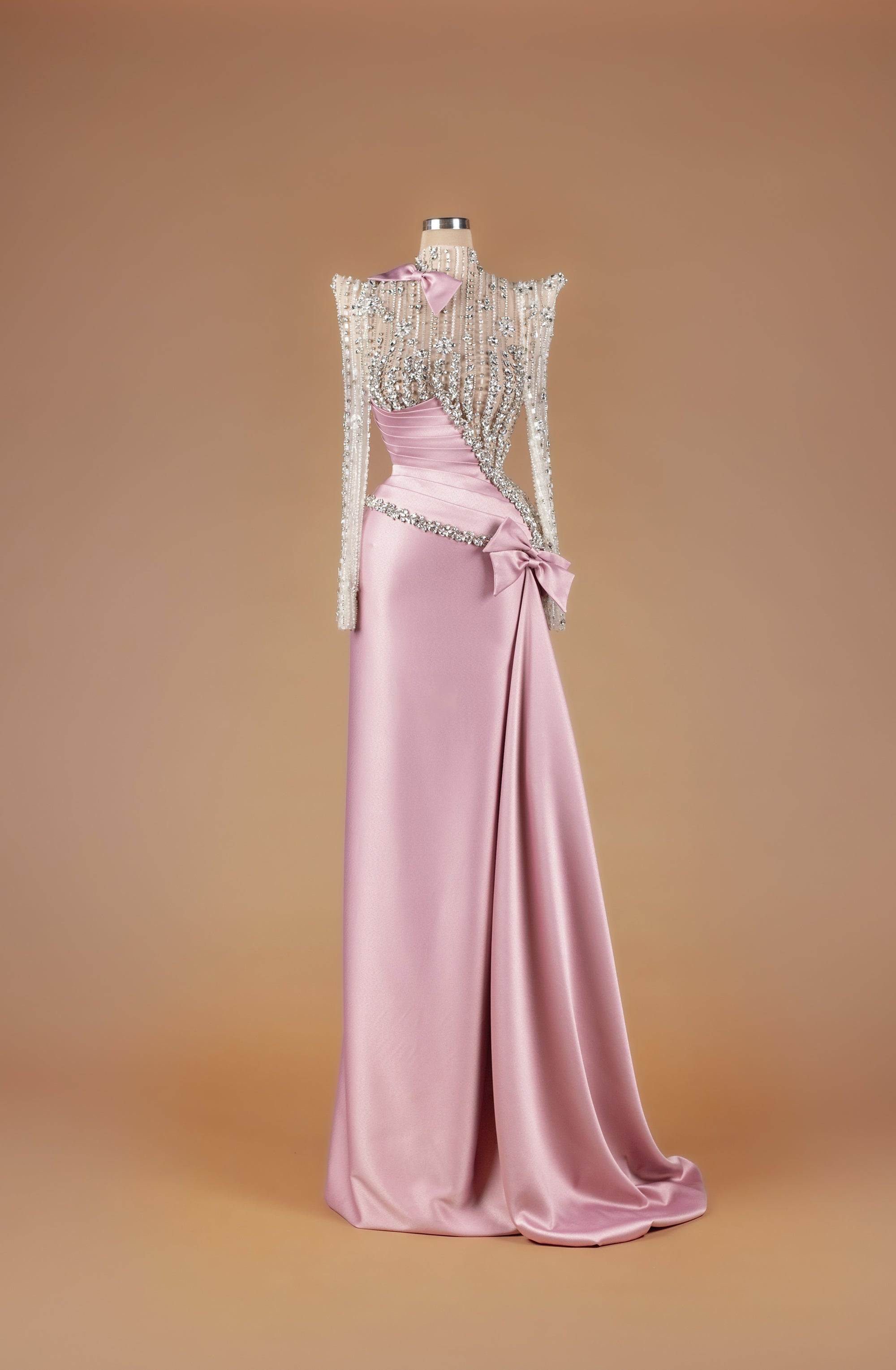 Sihëna Opaline Ribbon Sonnet — blush high-neck long-sleeve A-line gown with crystal and pearl beaded sheer bodice, satin bow and draped satin train.