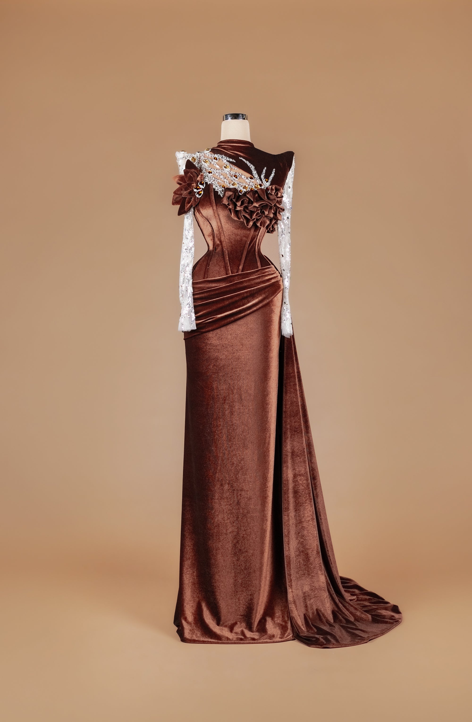 Sihëna Bronze Petal Crown — chocolate high-neck long-sleeve velvet mermaid gown with amber and clear crystal beadwork, 3D floral and draped sash train.