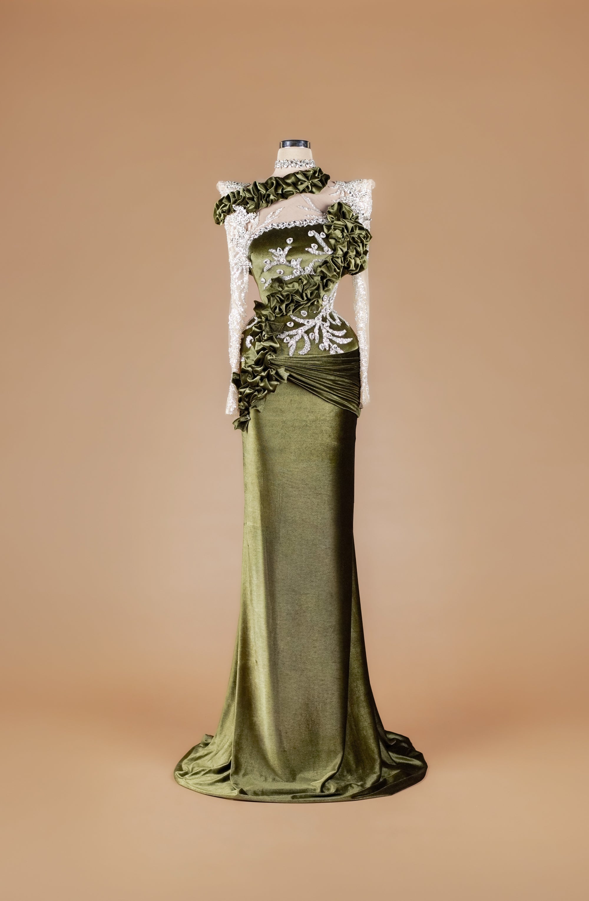 Sihëna Mossed Velvet Rhapsody — olive-green high-neck long-sleeve velvet mermaid gown with silver crystal appliqué, ruffled trim and draped train.
