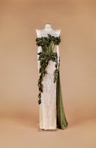 Sihëna Verdant Laurel Tapestry — olive-green high-neck long-sleeve mermaid gown with velvet corset, ruffled leaf detail and sheer ivory sequin skirt.