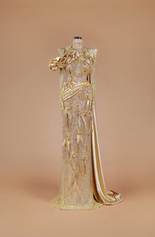 Sihëna Gilded Elysian Column — gold high-neck long-sleeve crystal-beaded illusion column gown with satin roses, feathers and gold floral embroidery.