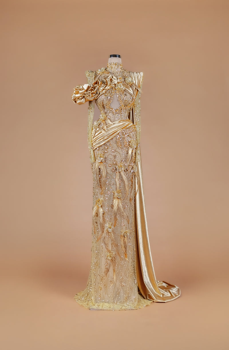 Sihëna Gilded Elysian Column — gold high-neck long-sleeve crystal-beaded illusion column gown with satin roses, feathers and gold floral embroidery.