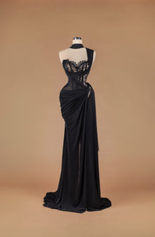 Sihëna Ebon Silhouette Whisper — black sweetheart sheer-lace corset column gown with draped crepe wrap, high slit and sweep train.