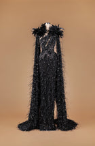 Sihëna Gilded Mocha Mosaic — black plunge sheer-tulle mermaid gown with feather collar and cape-sleeves, crystal beadwork and 3D floral appliqué.