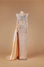 Sihëna Regal Frosted Arabesque — champagne square-neck long-sleeve pearl and crystal swag-beaded column gown with satin rose and draped overskirt.