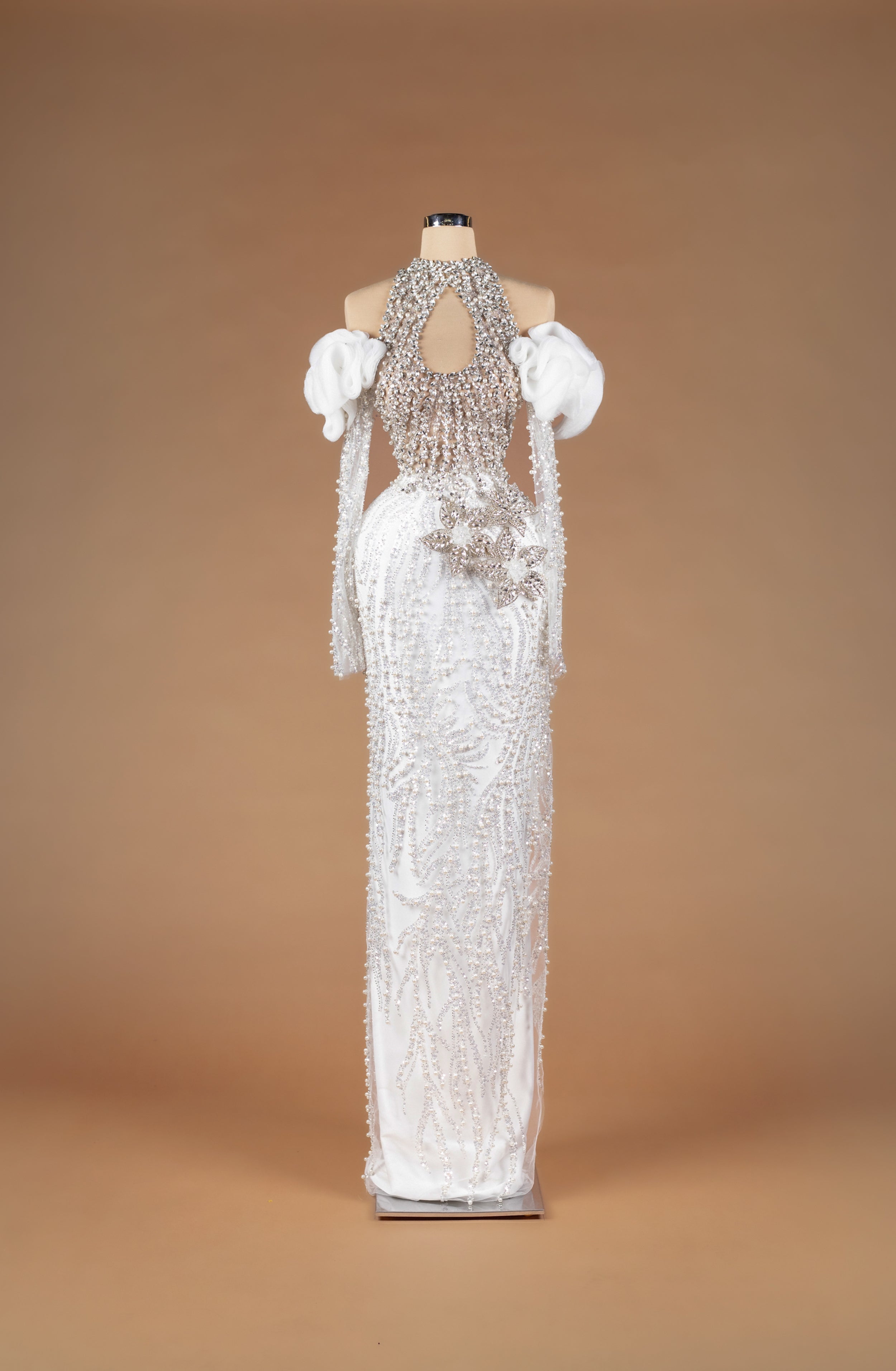 Sihëna Sunlit Harmony — ivory high-neck halter off-shoulder pearl and crystal beaded column gown with keyhole cutout and 3D floral waist appliqué.