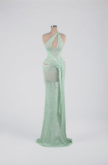 Sihëna Mint Mirage Ripple — mint one-shoulder sequin column gown with cutouts and a draped sash.