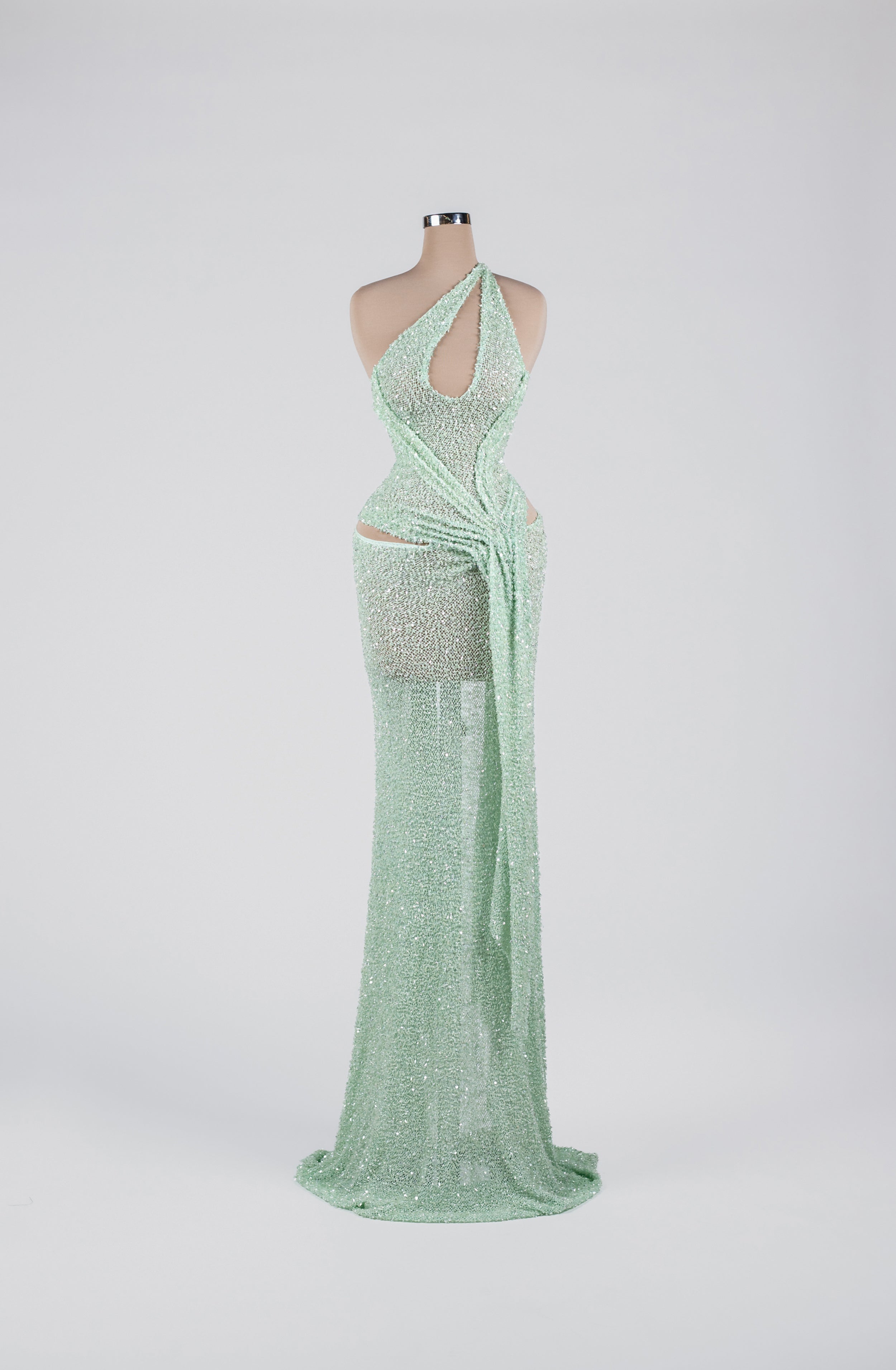 Sihëna Mint Mirage Ripple — mint one-shoulder sequin column gown with cutouts and a draped sash.