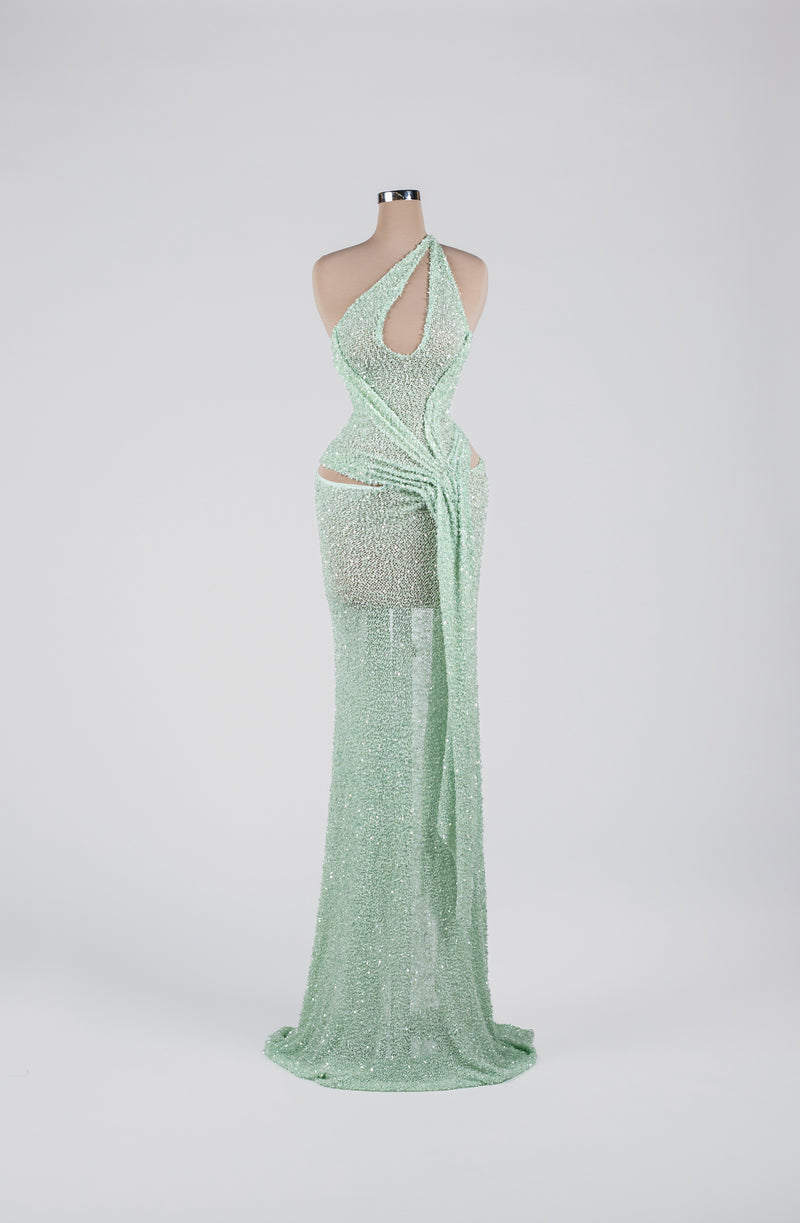 Sihëna Mint Mirage Ripple — mint one-shoulder sequin column gown with cutouts and a draped sash.