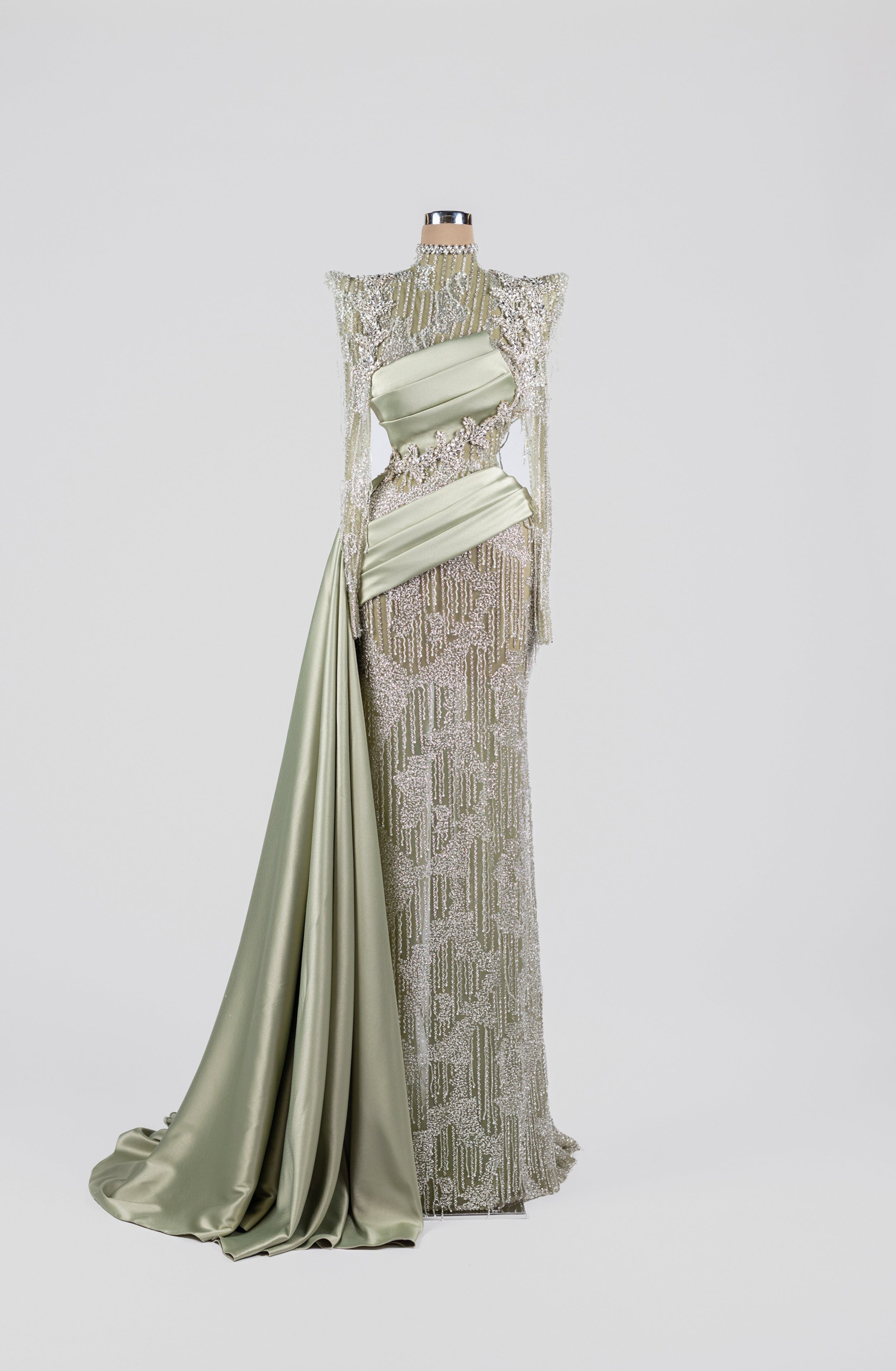 Sihëna Sage Lattice Reverie — sage-green high-neck long-sleeve gown with crystal-pearl beadwork and draped satin sash overskirt.