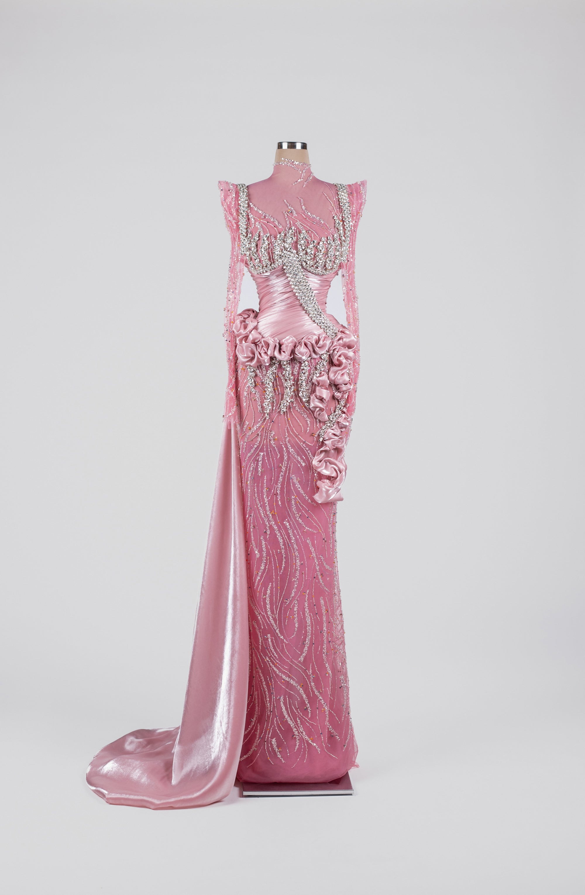 Sihëna Pink Radiance Rhapsody — pink high-neck long-sleeve satin gown with crystal beadwork, rosette ruffles and overskirt train.