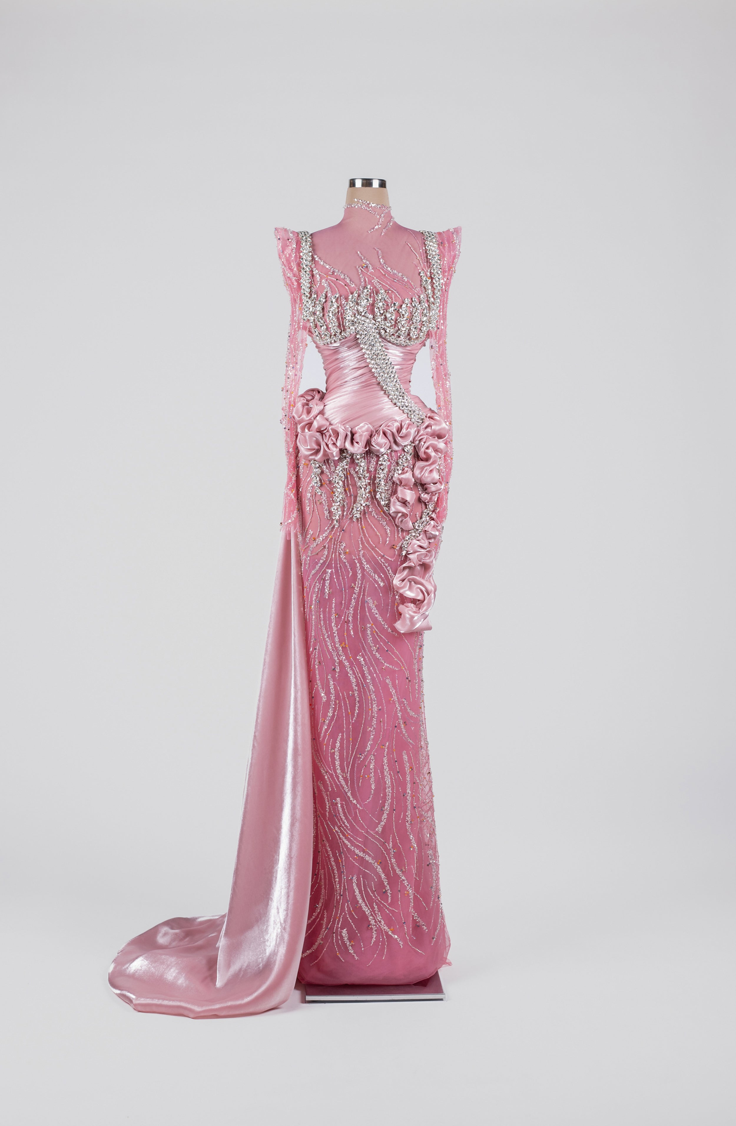 Sihëna Pink Radiance Rhapsody — pink high-neck long-sleeve satin gown with crystal beadwork, rosette ruffles and overskirt train.