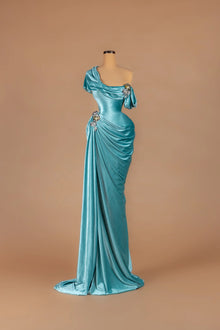 Sihëna Aegean Tide — teal asymmetric off-shoulder fitted gown with crystal accents on draped velvet.